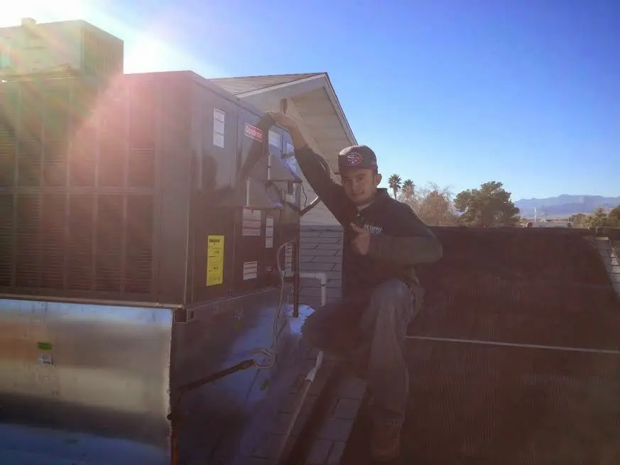 HVAC technician performing Boiler Repair on a rooftop unit in Thomasville